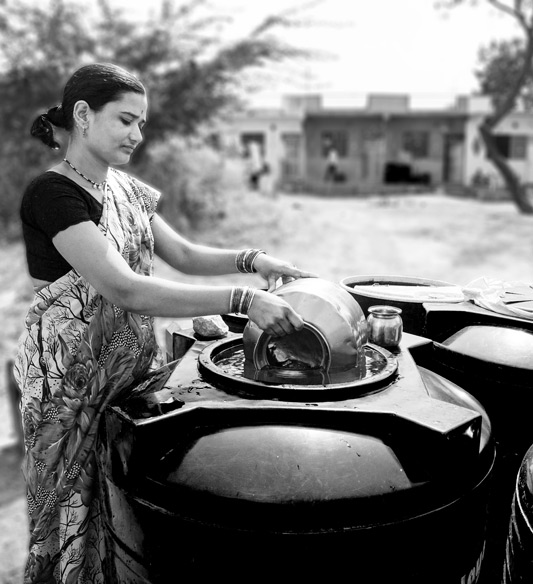 Plastic tanks on roadside near the house, filled with water from tanker. Drinking water is taken from here for use as and when required. The water is supposed to last for a number of days – Ahmednagar district, Maharashtra